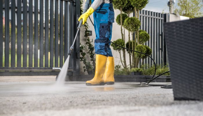 cleaning driveway with pressure washer